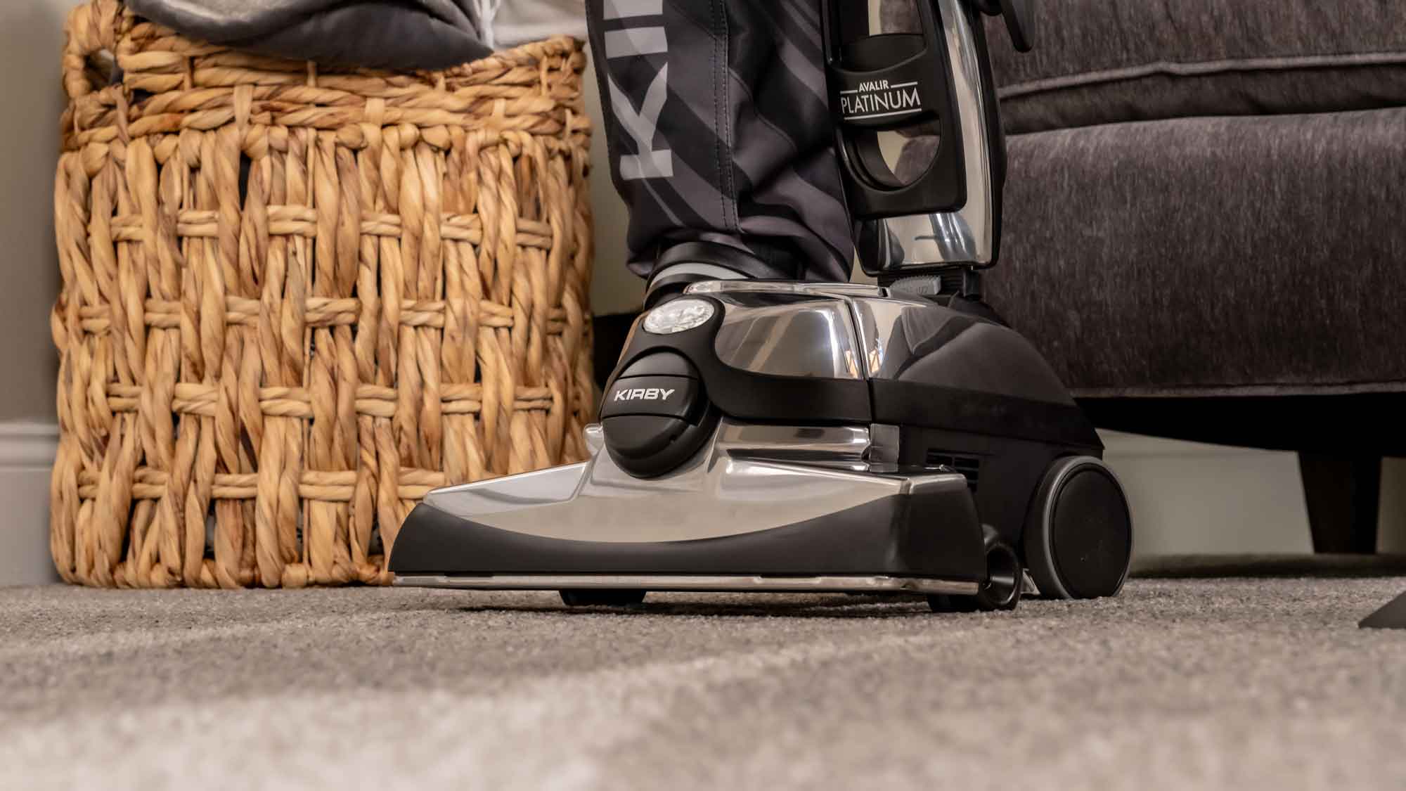 A Kirby vacuum's front hood and head light on a carpet