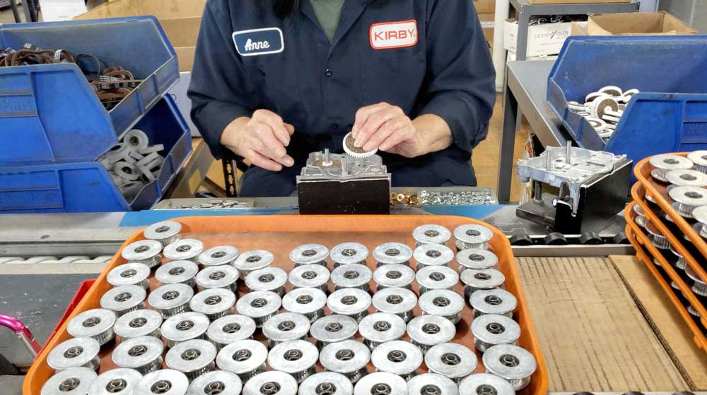 An American worker assembling a part in a factory