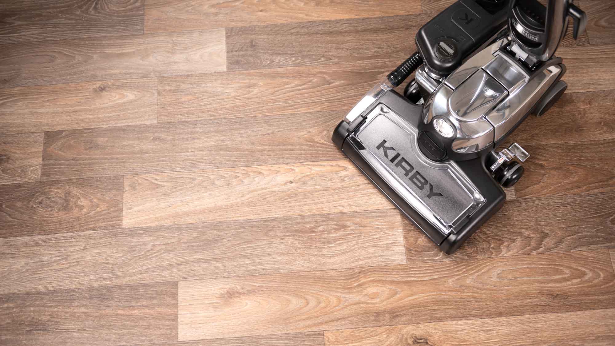 A Kirby vacuum's multi-surface shampoo system on a wooden floor