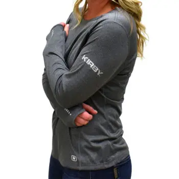 Woman wearing a gray long-sleeve athletic shirt with "KIRBY" text on the sleeve.