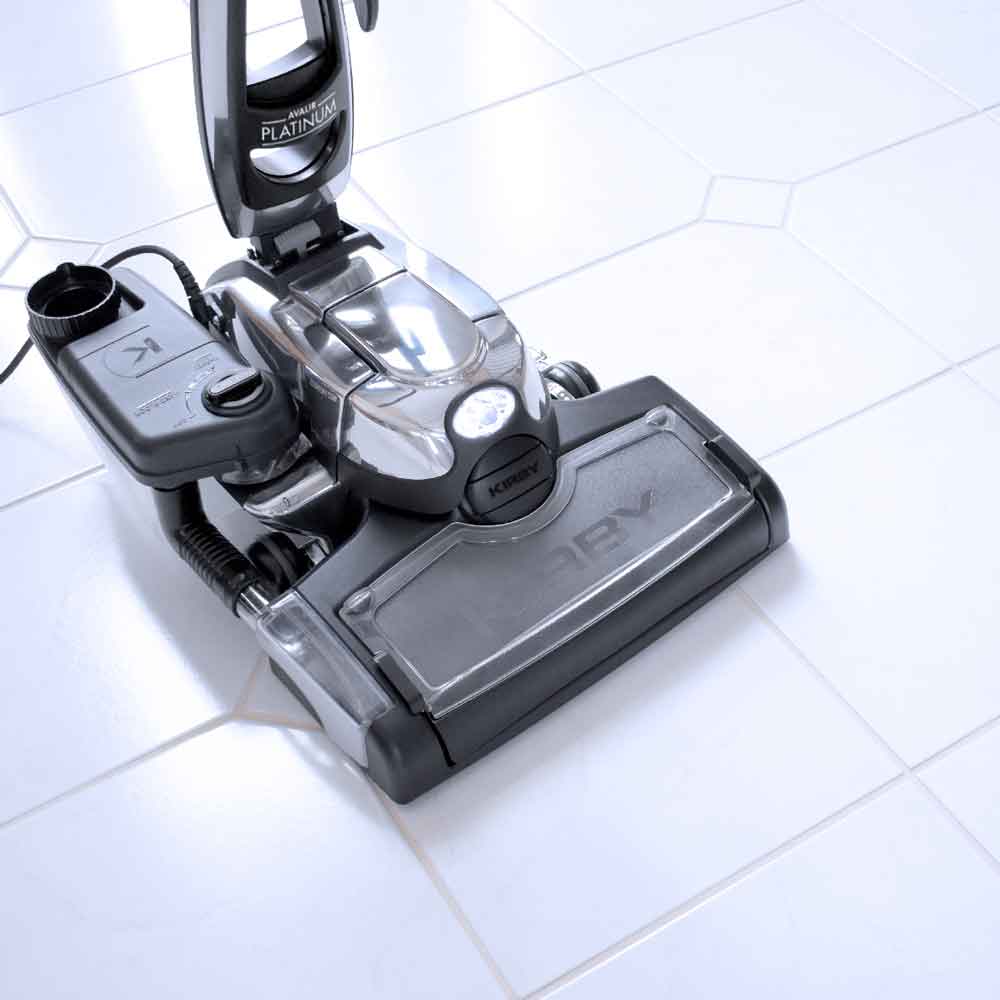 A Kirby vacuum with it's multi-surface shampoo system on tile