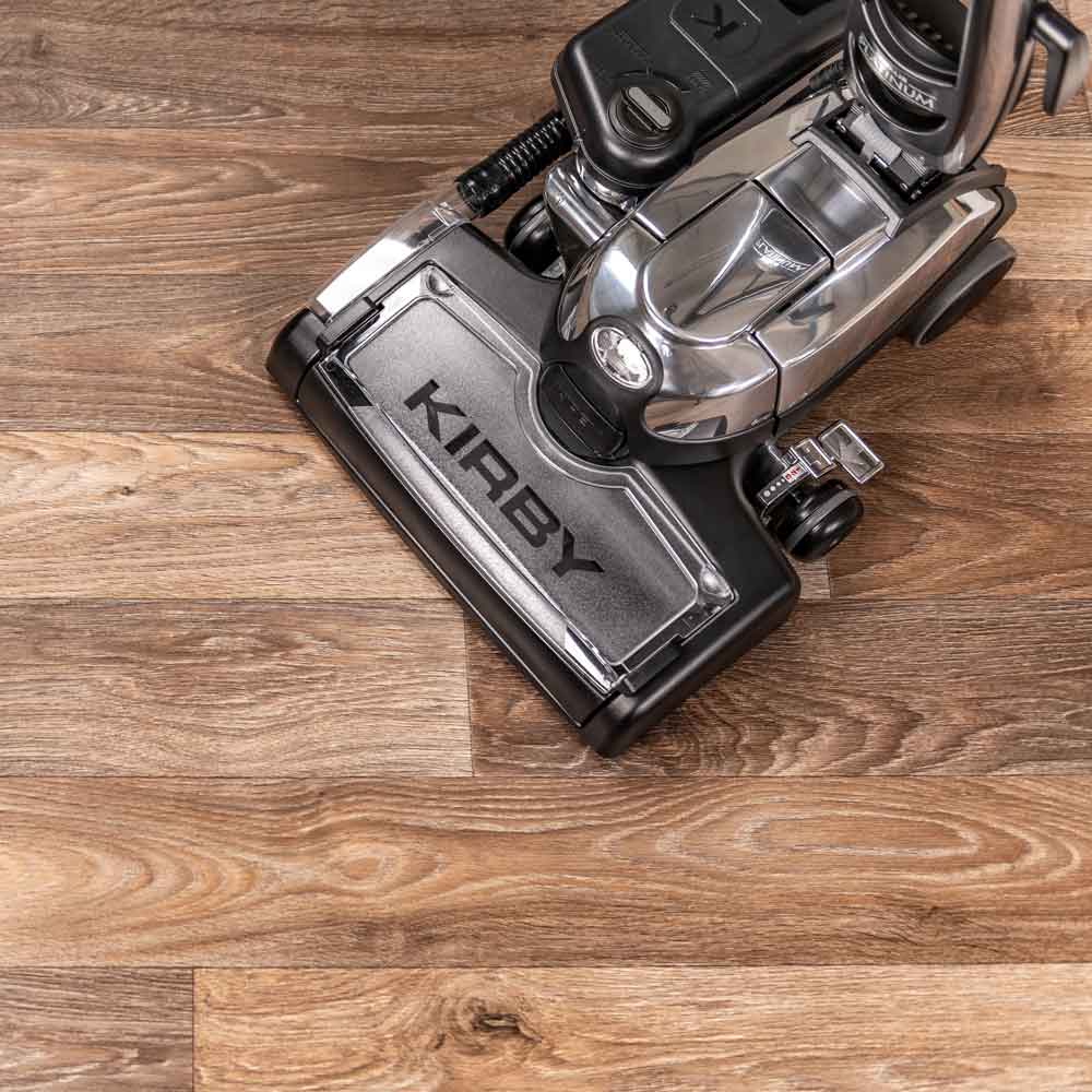 A Kirby vacuum with it's multi-surface shampoo system on a wooden floor