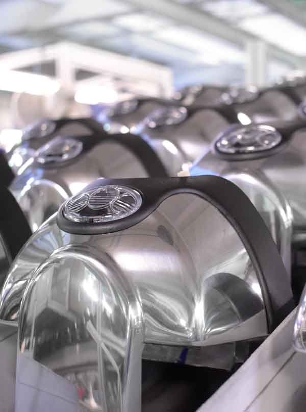 Rows of shiny aluminum Kirby vacuum parts.